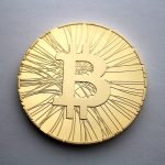 Physical bitcoin tokens arranged on a dark surface