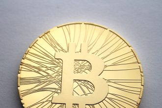 Physical bitcoin tokens arranged on a dark surface