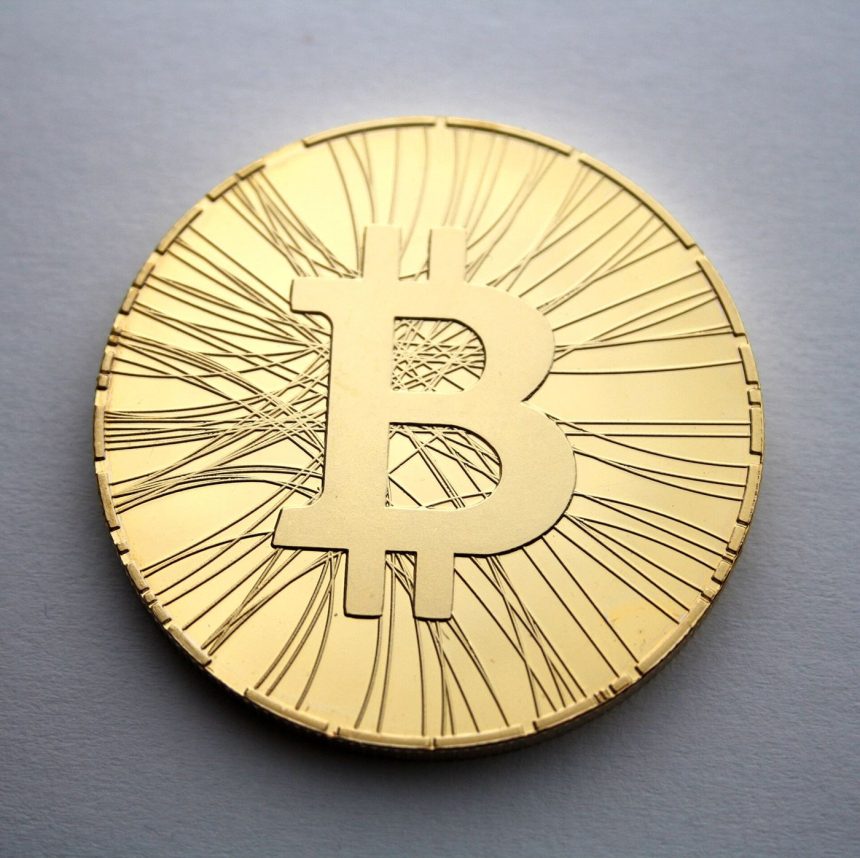 Physical bitcoin tokens arranged on a dark surface