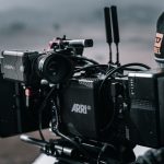 A professional cinema camera filming on a production set