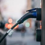 An electric car plugged into a public charging station
